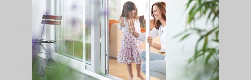 Mother and daughter in front of a sliding door with an insect screen installed.